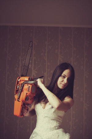 Seductive bride with bloody chainsaw  Indoors shooting の写真素材