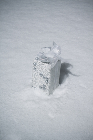 White christmas box laying in snow. Outdoors shooting. の写真素材