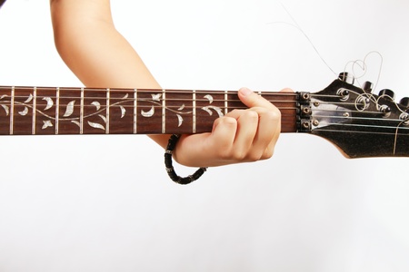 Hands of guitarist over white background