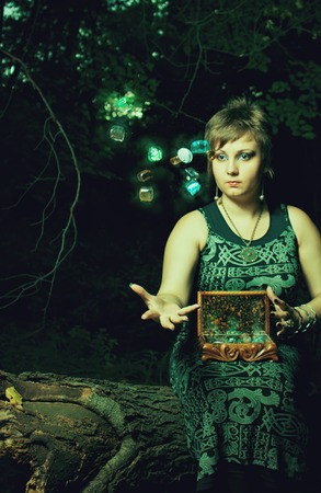 Witch casting a spell in the dark forest