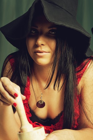 Seductive witch with mortar and pestleの写真素材