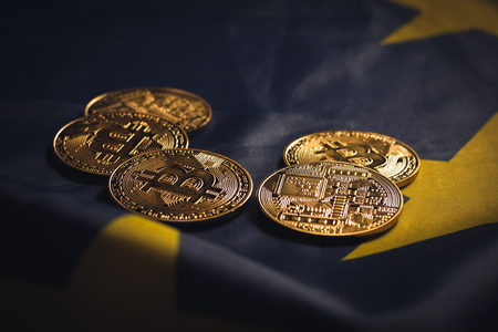 Golden bitcoins laying on  EU flagの写真素材