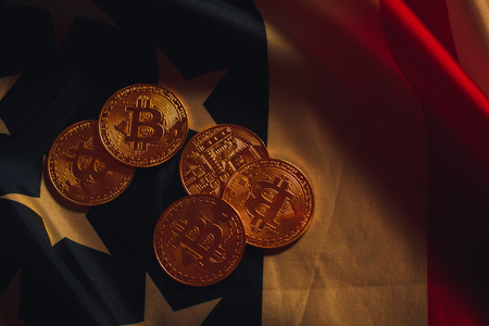 Golden bitcoins laying on USA flagの写真素材