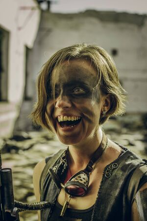 Crazy smiling postapocalyptic girl over a ruins