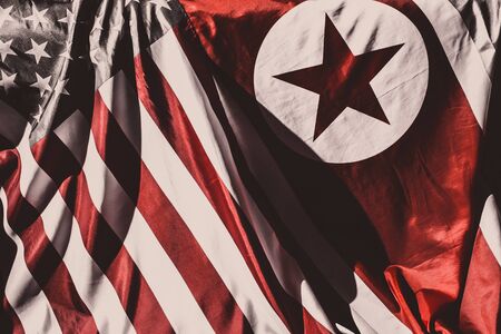 Closeup of flags of North Korea and USA 