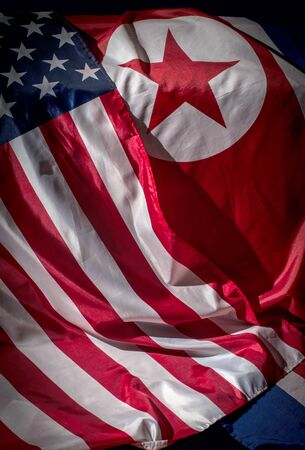Closeup of flags of North Korea and USA の写真素材