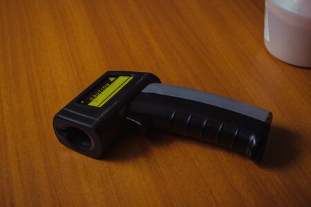 Infrared thermometer gun for measuring temperature. Covid-19 spread prevention concept.