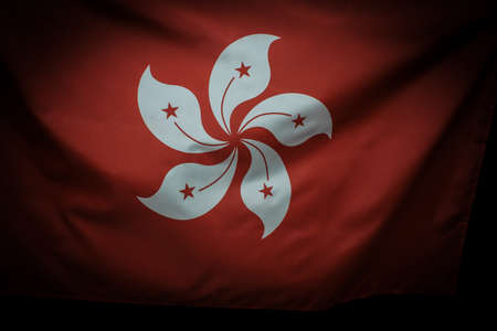 Hong Kong flag waving over dark background