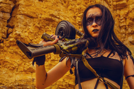 Merciless post apocalyptic raider with rifle posing over rocks