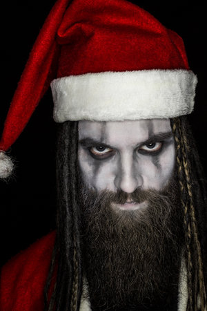 Portrait of angry Santa Claus over black background