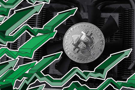 Bitcoin on graphic video card and green arrowsの写真素材