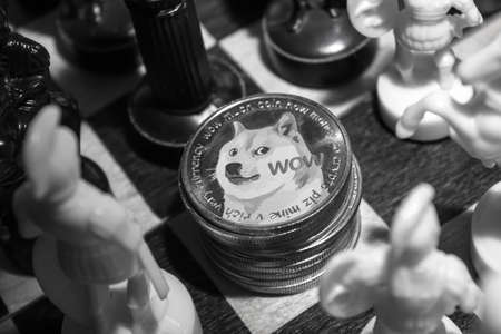 Stack of dogecoins on chessboard in soft light