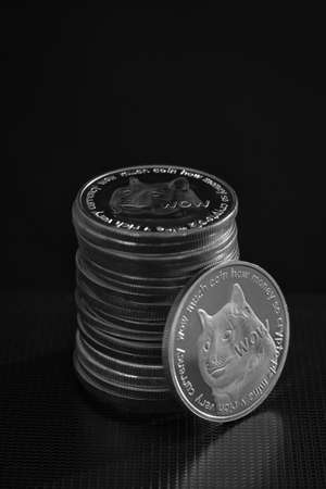 Stack of dogecoins over dark background