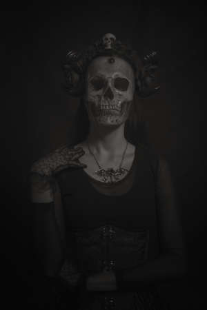 Horned gothic lady with skull instead faceの写真素材