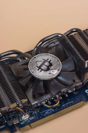 One silver bitcoin over graphic videocard