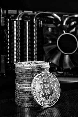 Stack of bitcoins over graphic video cardの写真素材