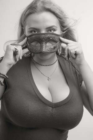 Pretty lady with mask over white backgroundの写真素材