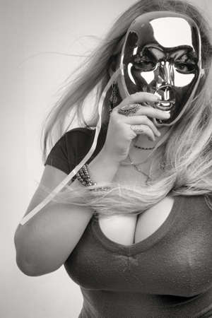 Pretty lady with mask over white backgroundの写真素材
