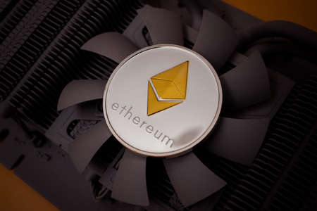 One silver ethereum coin over graphic videocard