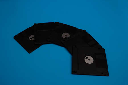 Stack of floppy disks over blue backgroundの写真素材