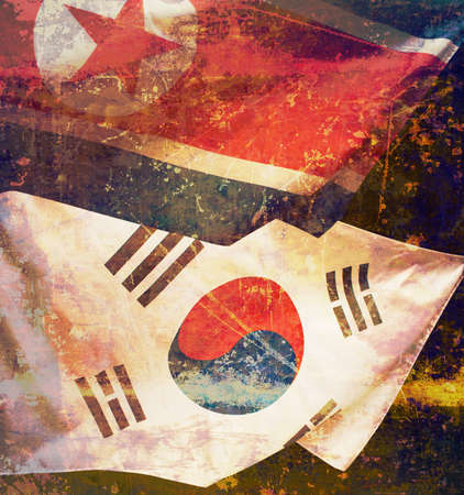 Waving flags of North Korea and South Korea over dark backgroundの写真素材