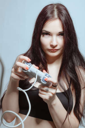 Cute asian girl posing with joystickの写真素材