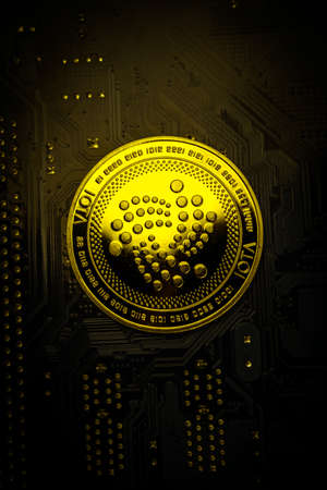 Closeup shot of one IOTA coin over motherboardの写真素材