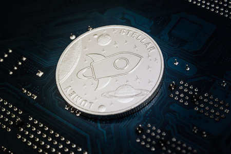 Closeup shot of one silver stellar coin over motherboardの写真素材