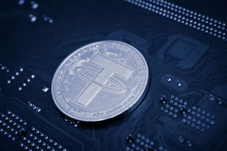 Closeup shot of tether coin over motherboardの写真素材