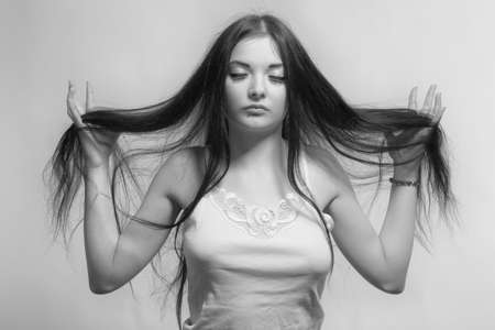 Pretty asian girl posing over grey background