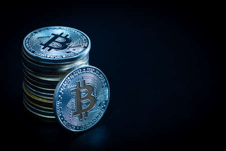 Stack of bitcoins over dark backgroundの写真素材