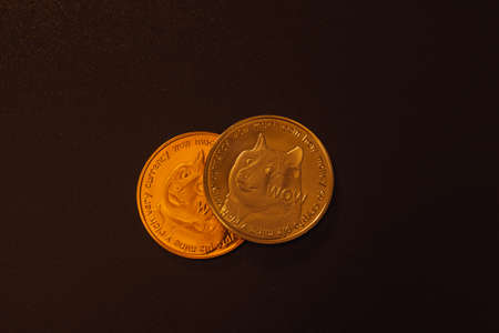 Two dogecoins over dark background