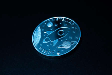 Stellar coin over dark backgroundの写真素材