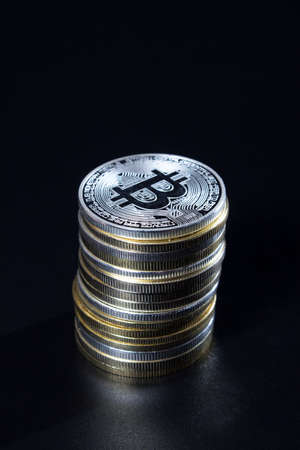 Stack of bitcoins over dark backgroundの写真素材