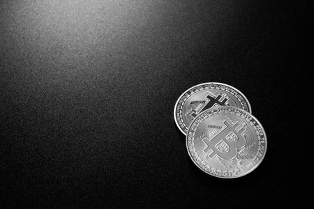 Two bitcoins over dark backgroundの写真素材