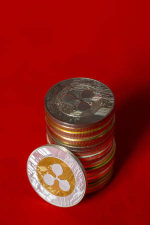 Stack of ripple coins over red background