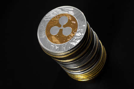 Stack of ripple coins over black backgroundの写真素材
