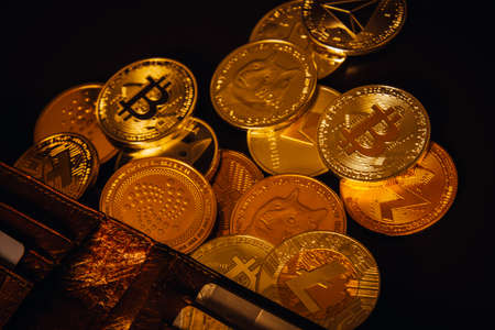 Stack of cryptocurrencies with wallet over dark backgroundの写真素材