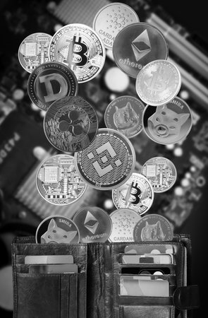 Stack of cryptocurrencies and brown wallet over motherboardの写真素材