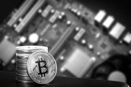 Stack of bitcoins over motherboard.の写真素材