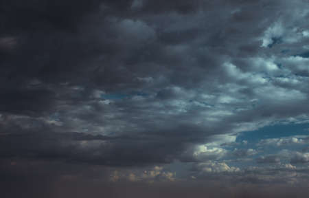 Blue sky with clouds in sunlightの写真素材