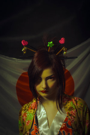 Beautiful asian young woman with katana over japanese flag