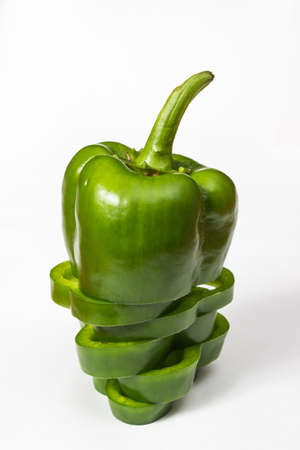 Close-up shot of chopped green pepper over white backgroundの写真素材