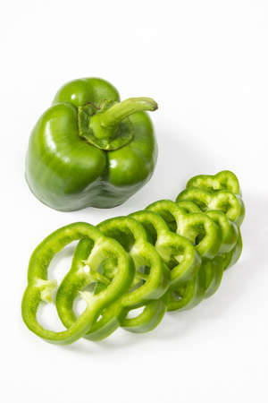 Close-up shot of chopped green pepper over white backgroundの写真素材