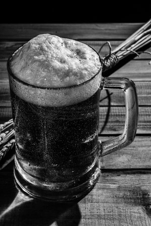 Close-up shot of mug of beer over wooden table