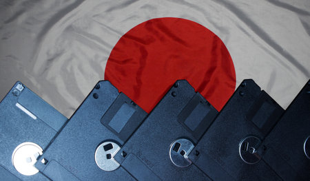 Stack of floppy disks over japanese flag