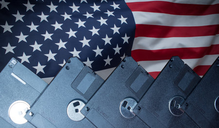 Stack of floppy disks over USA flagの写真素材