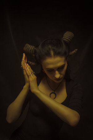 Horned faun posing over dark backgroundの写真素材