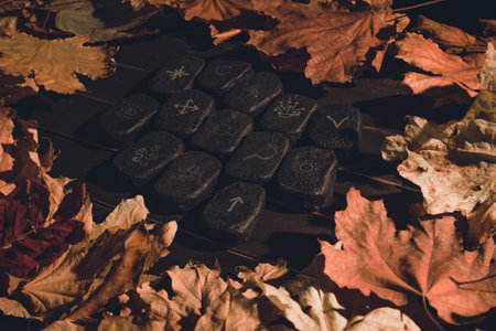 Wicca divination runes over wooden planksの写真素材