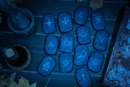 Wicca divination runes over wooden planksの写真素材